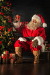 © Milles Studio - Santa is placing gift boxes under Christmas tree