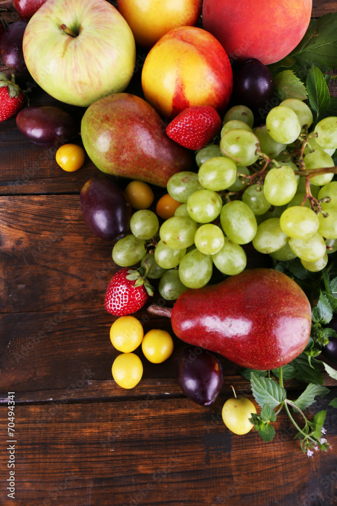 Different berries and fruits on wooden table close-up