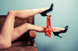 Seductive woman in heels on sofa