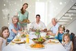 © WavebreakmediaMicro - Composite image of family having meal at dining table