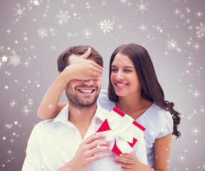 Poster - Composite image of woman surprising boyfriend with gift