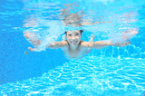 Fototapeta Łazienka - Happy active underwater child swims in pool, kids sport