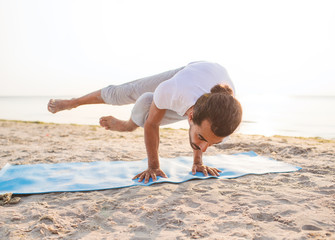 Canvas Print - man doing yoga exercises outdoors