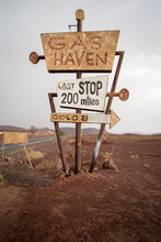 Tall Vintage Gas Sign Standing In The Desert