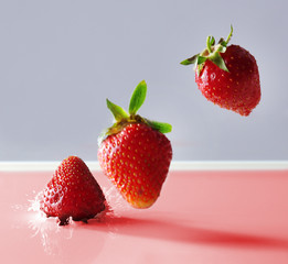 Canvas Print - Delicious fresh strawberry falling into splashing milk