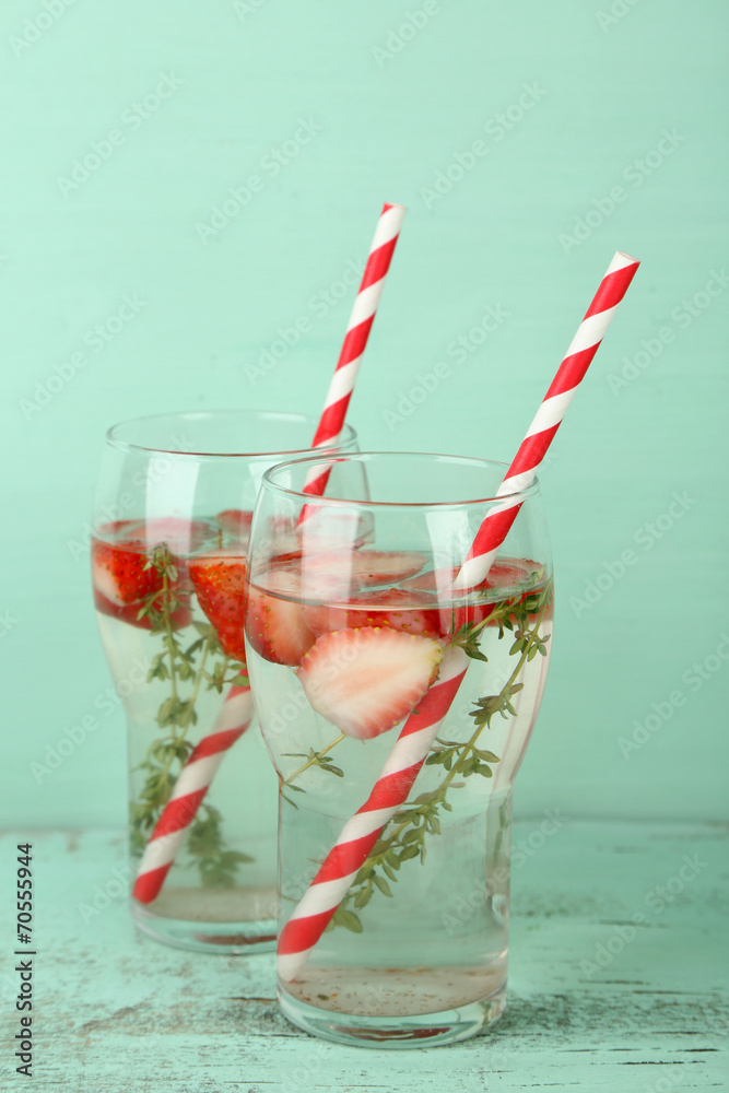 Tasty cool beverage with strawberries and thyme,