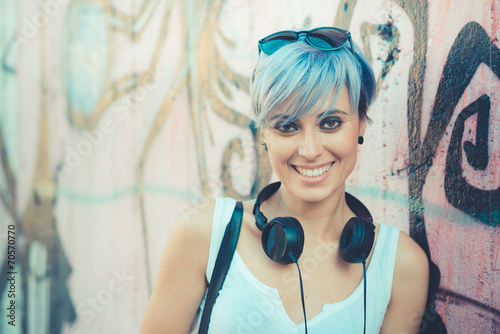 Fotomural young beautiful short blue hair hipster woman with headphones mu