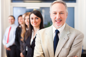 Poster - Businessman in front of his team