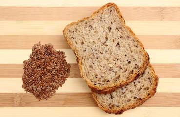 Linseed on cutting board and slices of wholemeal bread