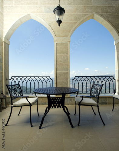 Fototapeta na wymiar Table with chairs on a mountain view terrace