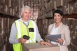 © WavebreakmediaMicro - Warehouse worker scanning box with manager