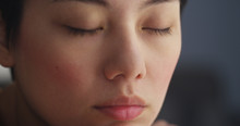 Close Up Of Chinese Woman Resting With Eyes Closed
