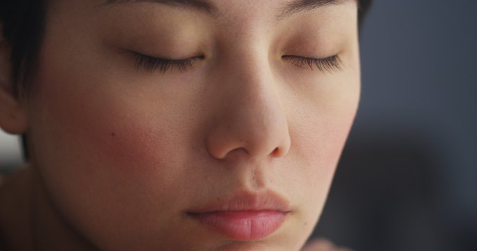 Wall Mural -  - Close up of Chinese woman resting with eyes closed
