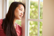 © Monkey Business - Thoughtful Asian Woman Looking Out Of Window
