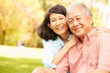 © Monkey Business - Portrait Of Senior Asian Couple Sitting In Park Together