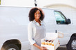 © Monkey Business - Female Baker Delivering Cakes Standing In Front Of Van
