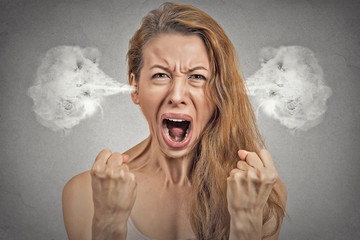 angry young woman blowing steam coming out of ears