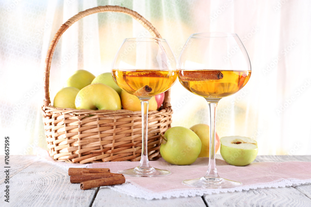 still life with apple cider and fresh apples on wooden table