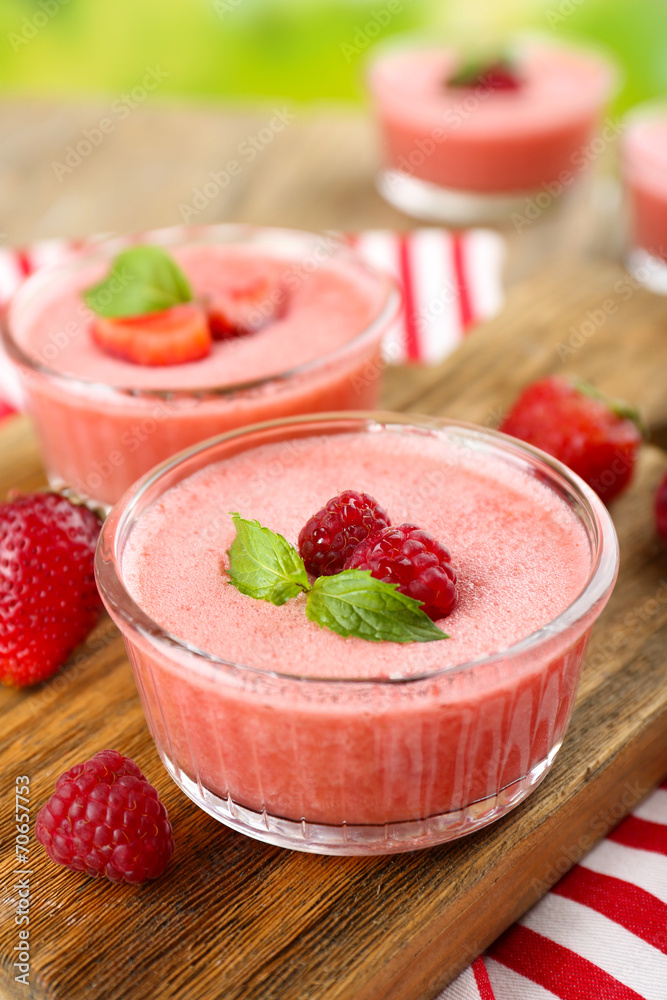 Delicious berry mousse in bowls on table close-up