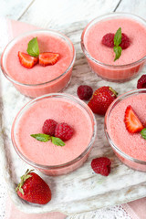 Wall Mural - Delicious berry mousse in bowls on table close-up