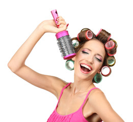 Wall Mural - Beautiful girl in hair curlers isolated on white