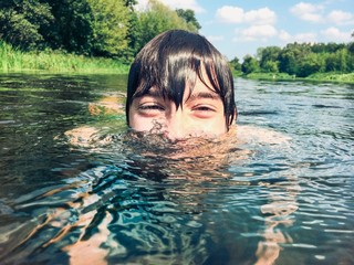 Young boy splashing in the water