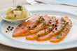 Smoked  salmon and ingredients in plate on table