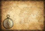 Fototapeta Mapy - old brass or golden compass with world map background