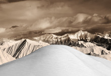 Top Of Off-piste Snowy Slope And Sepia Mountains