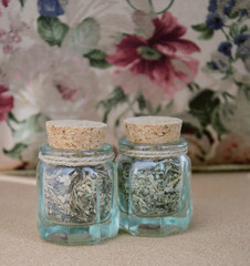 Two small bottles with dried herbs