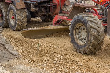 Close up of motor grader working on gravel leveling 2