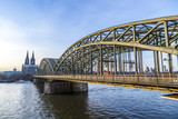 Fototapeta Mosty linowy / wiszący - Cologne Cathedral and skyline, Germany