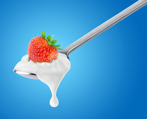Poster - Isolated yogurt. Spoon of yogurt with strawberry on top over blue background, with clipping path