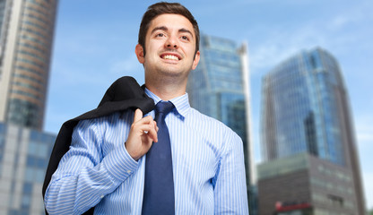 Wall Mural - Young businessman holding the jacket over his shoulder