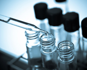 Wall Mural - laboratory research, dropping liquid to test tube