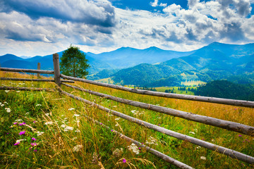 Wall Mural - amazing mountain landscape with fog and a haystack