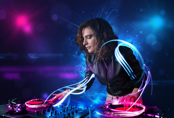 Disc jockey playing music with electro light effects and lights