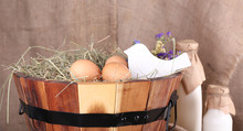 Big Round Basket With Dried Grass, Milk And Fresh Eggs