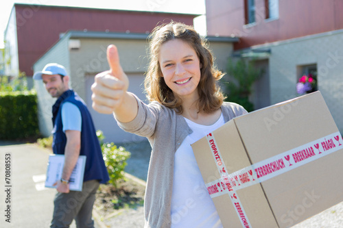 Fotografie, Obraz Young attractive woman happy to receive parcel