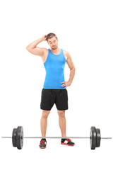 Sticker - Doubtful male athlete looking at a barbell