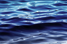 Soft Rolling Deep Blue Waves On Water Surface