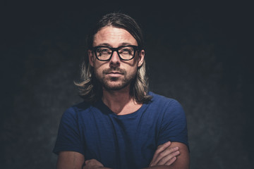 Authentic studio portrait of man with long blonde hair and retro