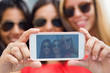 © nenetus - Three friends taking photos with a smartphone