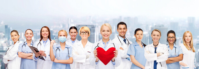 Wall Mural - smiling doctors and nurses with red heart