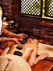 Fototapete - Woman having Ayurvedic stone massage.