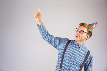 Poster - Geeky hipster wearing party hat pointing