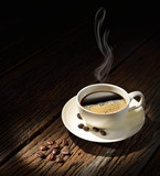 Fototapeta Mapy - Cup of coffee with smoke and coffee beans on old wooden table