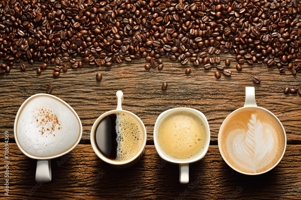 Variety of cups of coffee and coffee beans on old wooden table - obrazy, fototapety, plakaty 