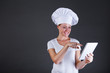 © Wisiel - woman chef with tablet over dark background