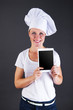 © Wisiel - woman chef with tablet over dark background